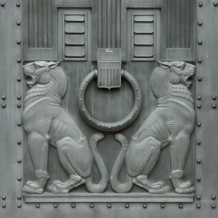 Art Deco stylized lions on the entrance doors of the U.S. Department of Justice, symbolizing defense and enforcement in contentious regulation and disputes.